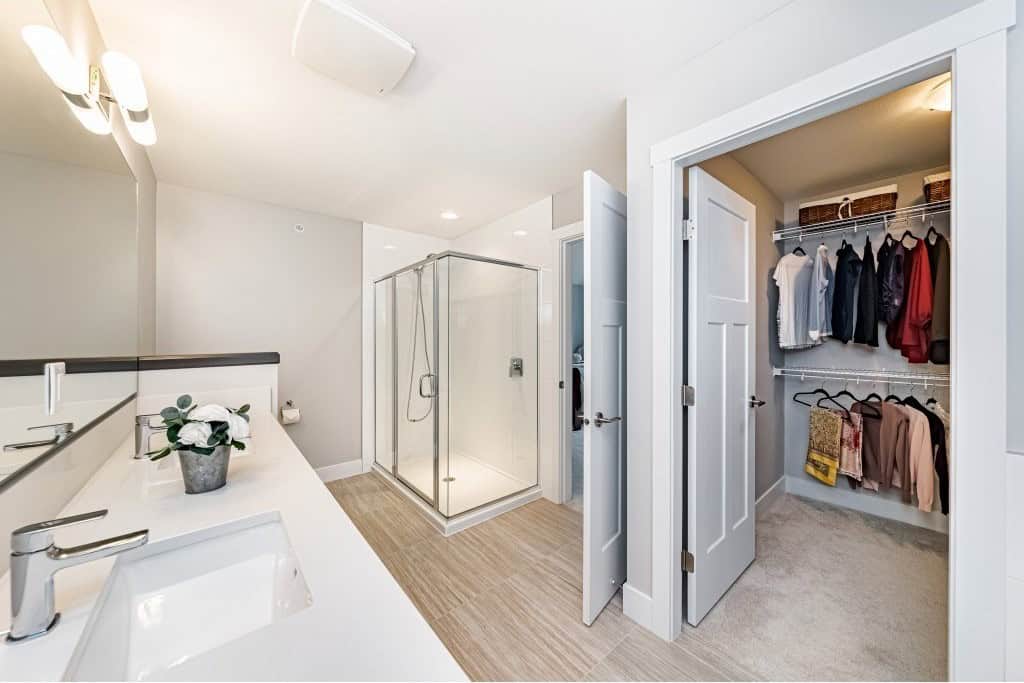 Modern bathroom with walk-in shower and spacious closet, featuring contemporary fixtures and ample storage, perfect for home buyers seeking comfort and convenience in BC.