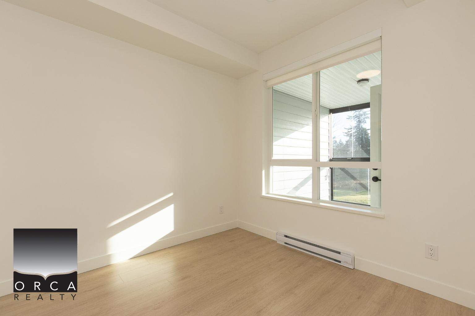 Bright and airy condo interior with large window, natural light, modern flooring, perfect for Vancouver real estate buyers seeking stylish apartments.