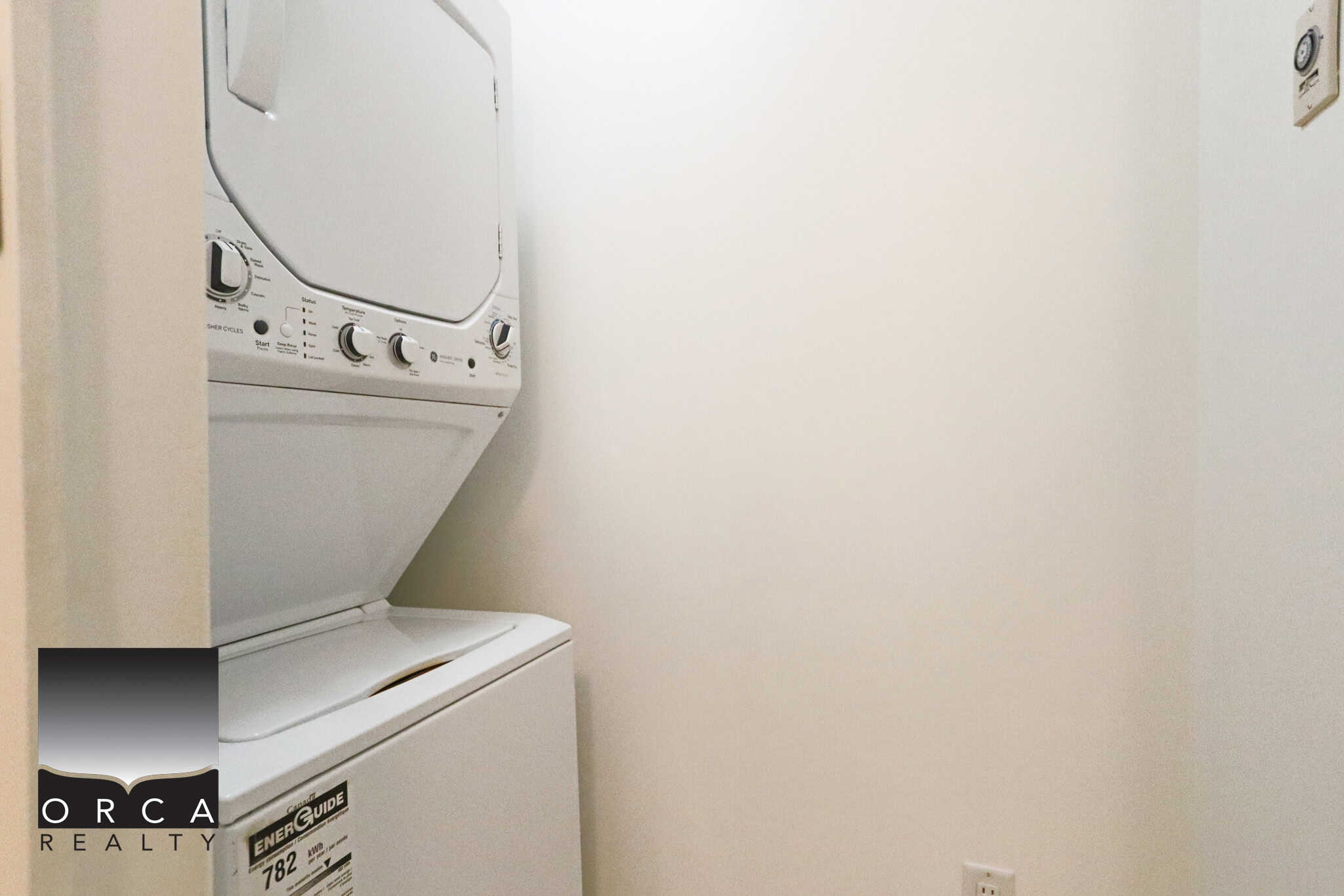 Laundry space with stacked washer and dryer in a North Vancouver apartment.