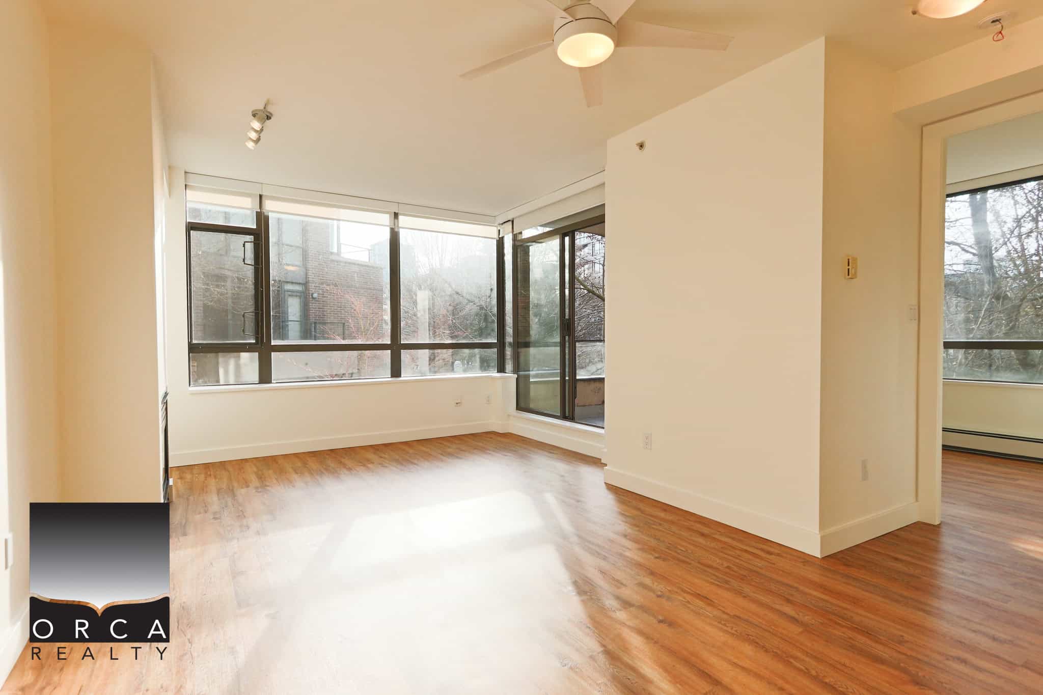 Bright North Vancouver condo with large windows and hardwood floors.