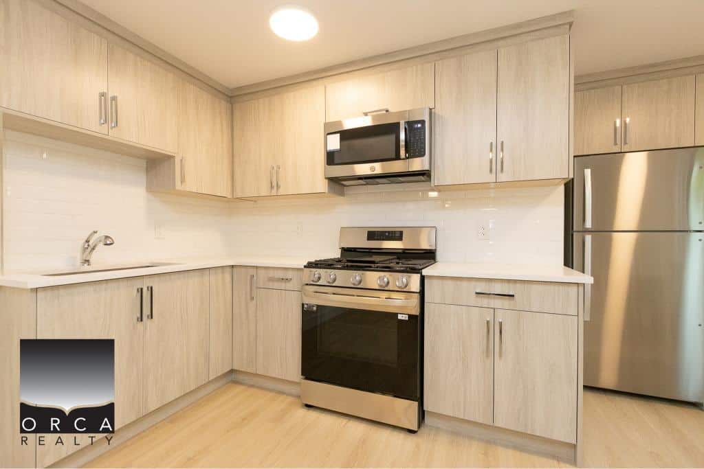 Bright modern kitchen with light wood cabinets, stainless steel appliances, and ample counter space, ideal for Vancouver area real estate listings.