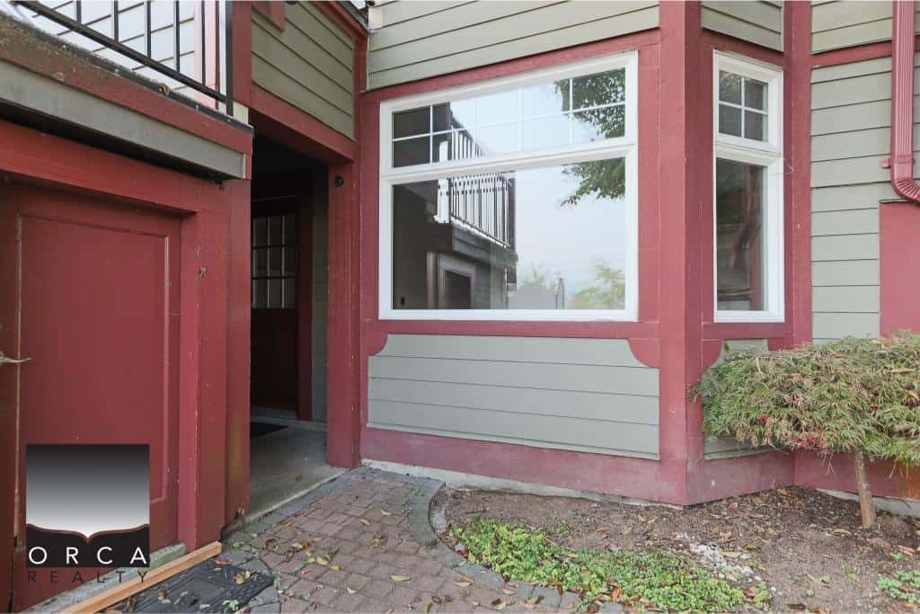 Charming Vancouver townhouse with updated exterior, large windows, and well-maintained landscaping, perfect for buyers seeking a cozy, modern property in a desirable neighbourhood.