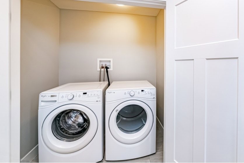 Washer and dryer in laundry room, modern appliances in a clean home, laundry area for convenience, part of home listing by Orca Realty Inc., functional utility space for residential properties.