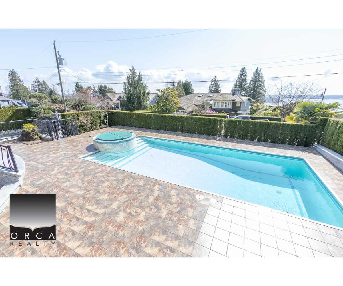 Luxury private backyard with swimming pool and hot tub, overlooking scenic neighborhood views, perfect for outdoor entertaining and relaxation.