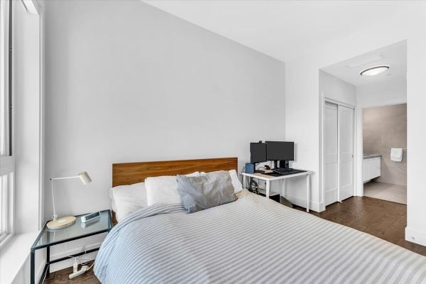 Bright, contemporary bedroom in Vancouver featuring a comfortable bed, sleek furniture, and ample natural light, ideal for urban living and real estate showcasing in the Granville Street area.