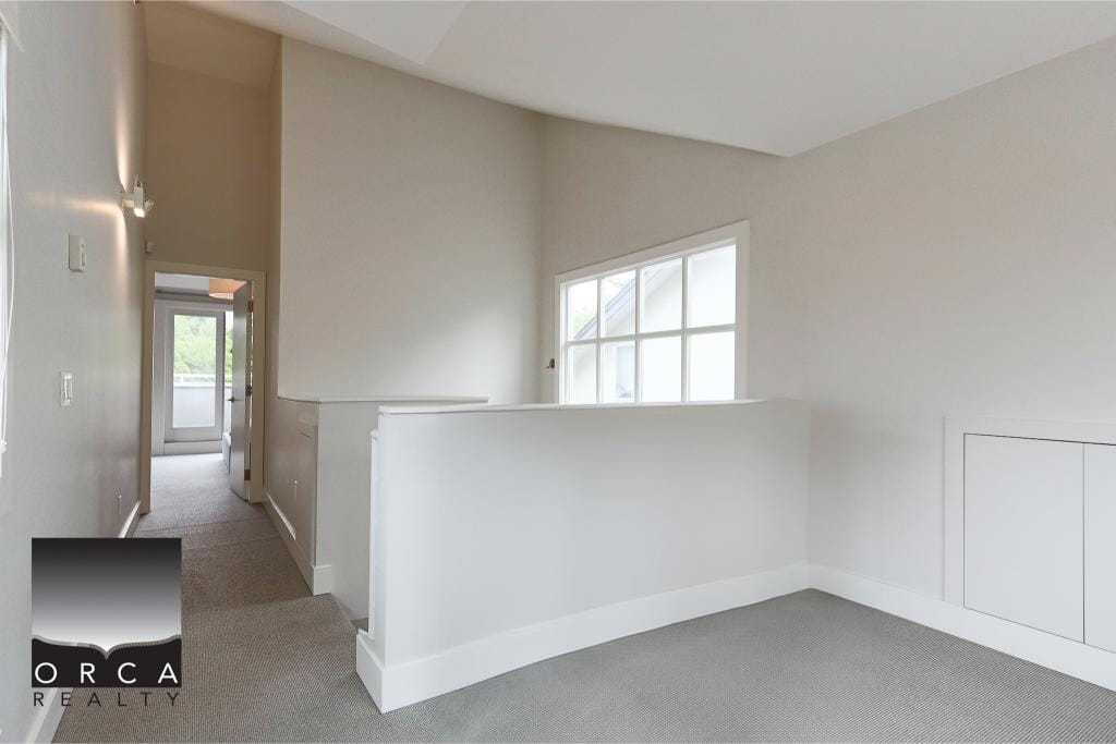 Spacious modern interior of a residential property listed by Orca Realty Inc. showcasing bright natural light, clean walls, and contemporary design ideal for Vancouver real estate buyers.
