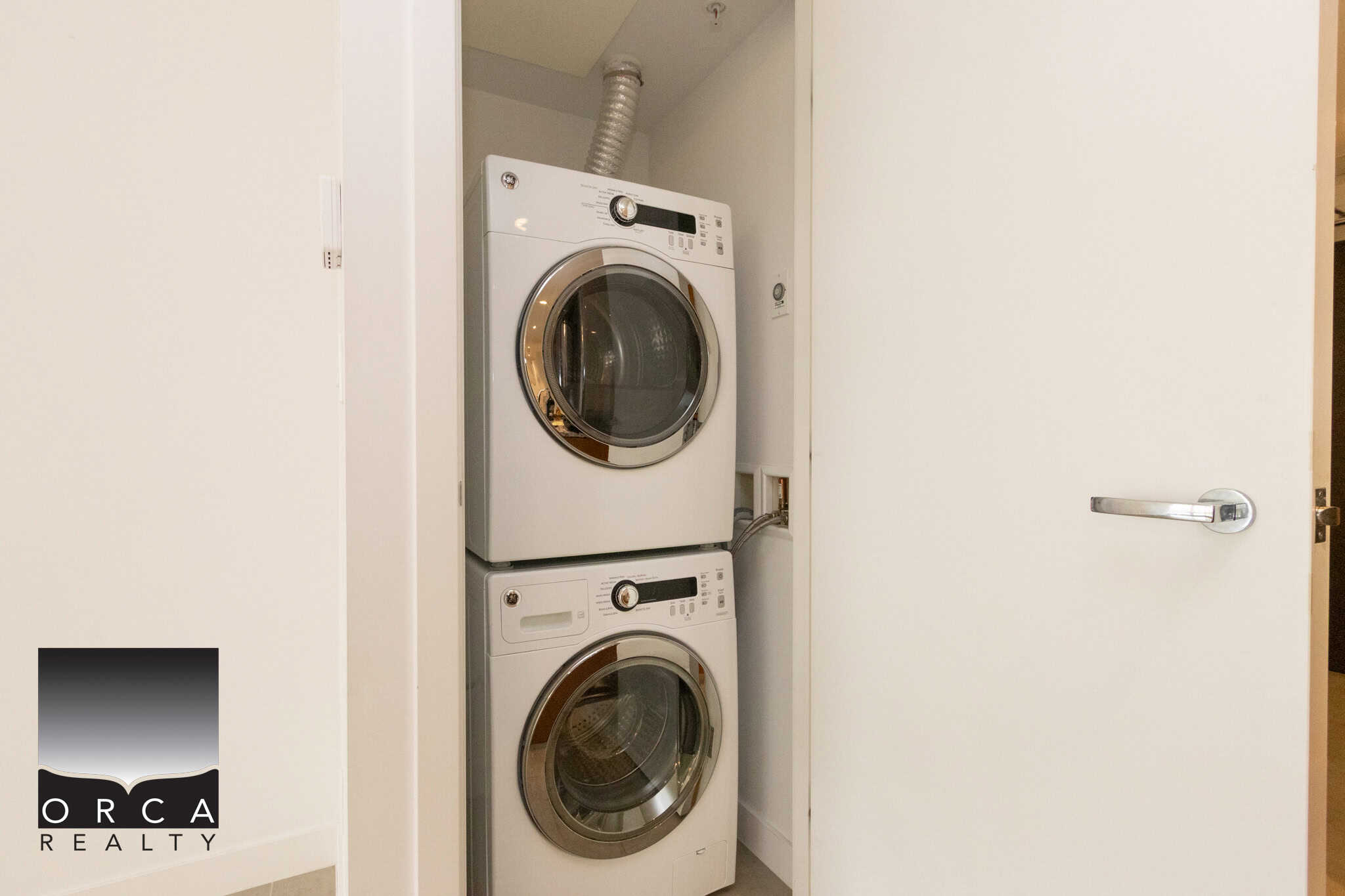 Modern front-loading washer and dryer stack in a laundry closet, ideal for Vancouver homes. Energy-efficient appliances perfect for busy households seeking reliable laundry solutions.