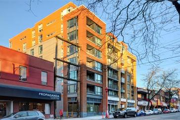 Modern multi-story apartment building in downtown Vancouver with retail spaces on the ground floor, showcasing contemporary urban living options.