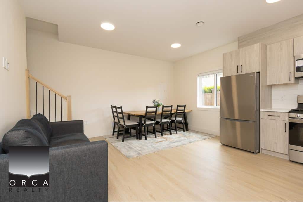 Spacious modern kitchen and dining area in a Vancouver home, featuring stainless steel appliances, light wood cabinetry, and a welcoming open-concept layout.