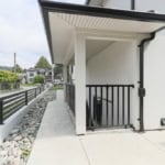 Modern condo entrance with stairs and black railing, Vancouver real estate, contemporary architecture, outdoor space, secure entry, residential property, Orca Realty Inc.