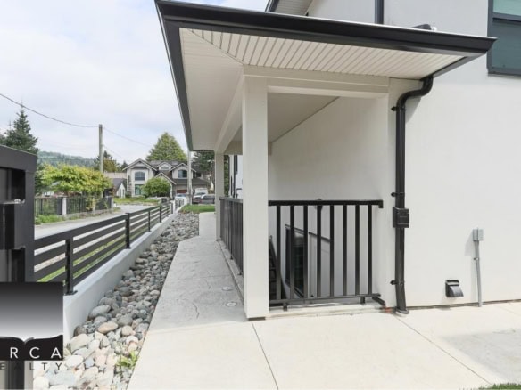 Modern condo entrance with stairs and black railing, Vancouver real estate, contemporary architecture, outdoor space, secure entry, residential property, Orca Realty Inc.