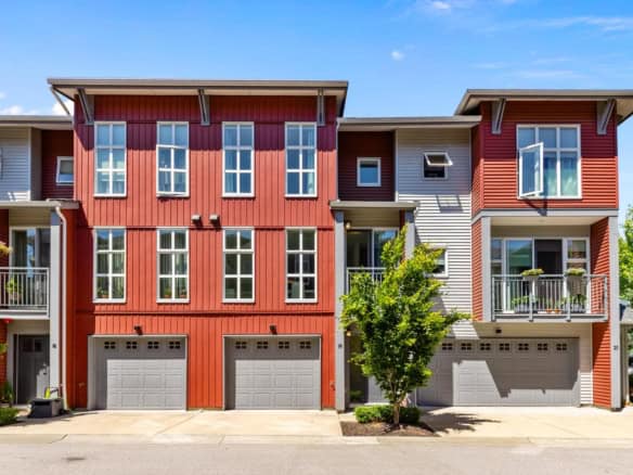 Colorful modern multi-family residential buildings with garage, balcony, and large windows, showcasing contemporary architecture and prime location in a well-maintained neighbourhood.