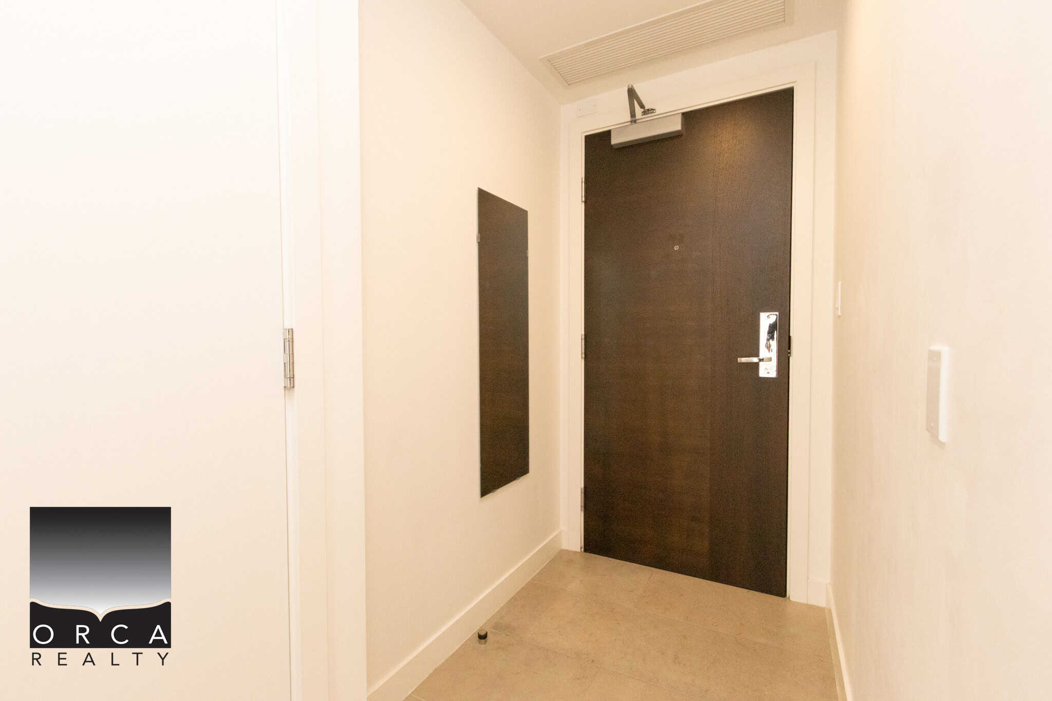 Modern condo entrance door with secure lock system in a Vancouver property listing.