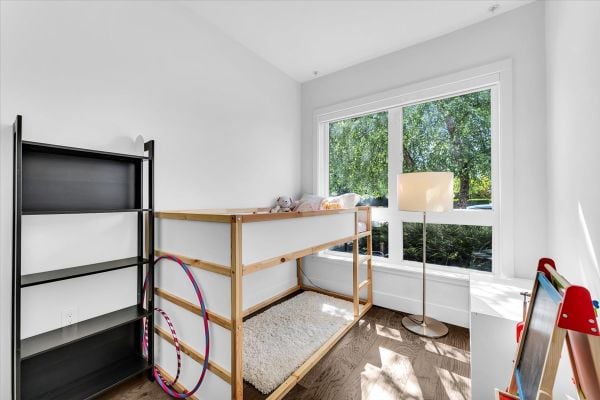 Bright Vancouver bedroom with large window and modern furnishings.