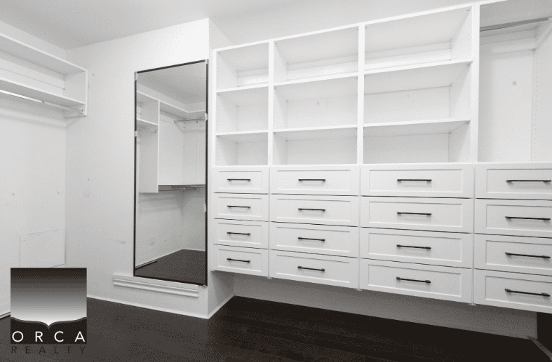 Closet with built-in shelves and drawers in a modern home, showcasing convenient storage solutions for real estate listings in BC.