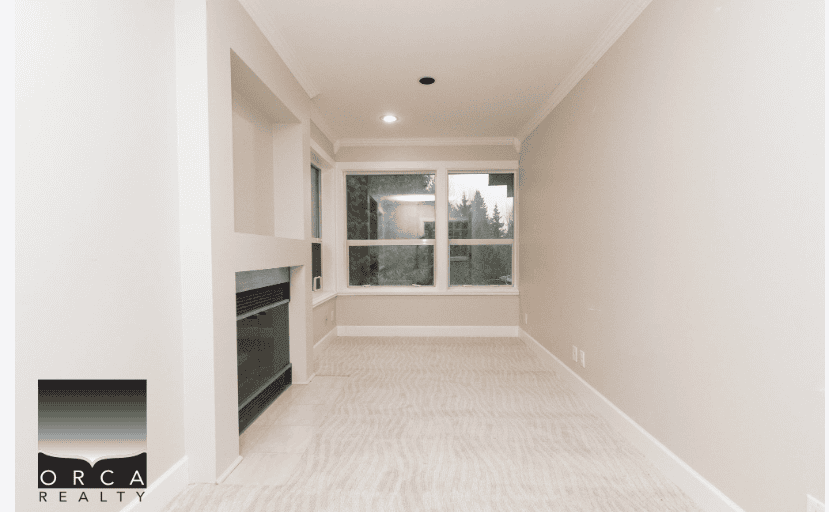 Bright living room with large windows and natural light, ideal for Vancouver real estate buyers seeking modern homes. Orca Realty Inc. offers expert property services in BC.