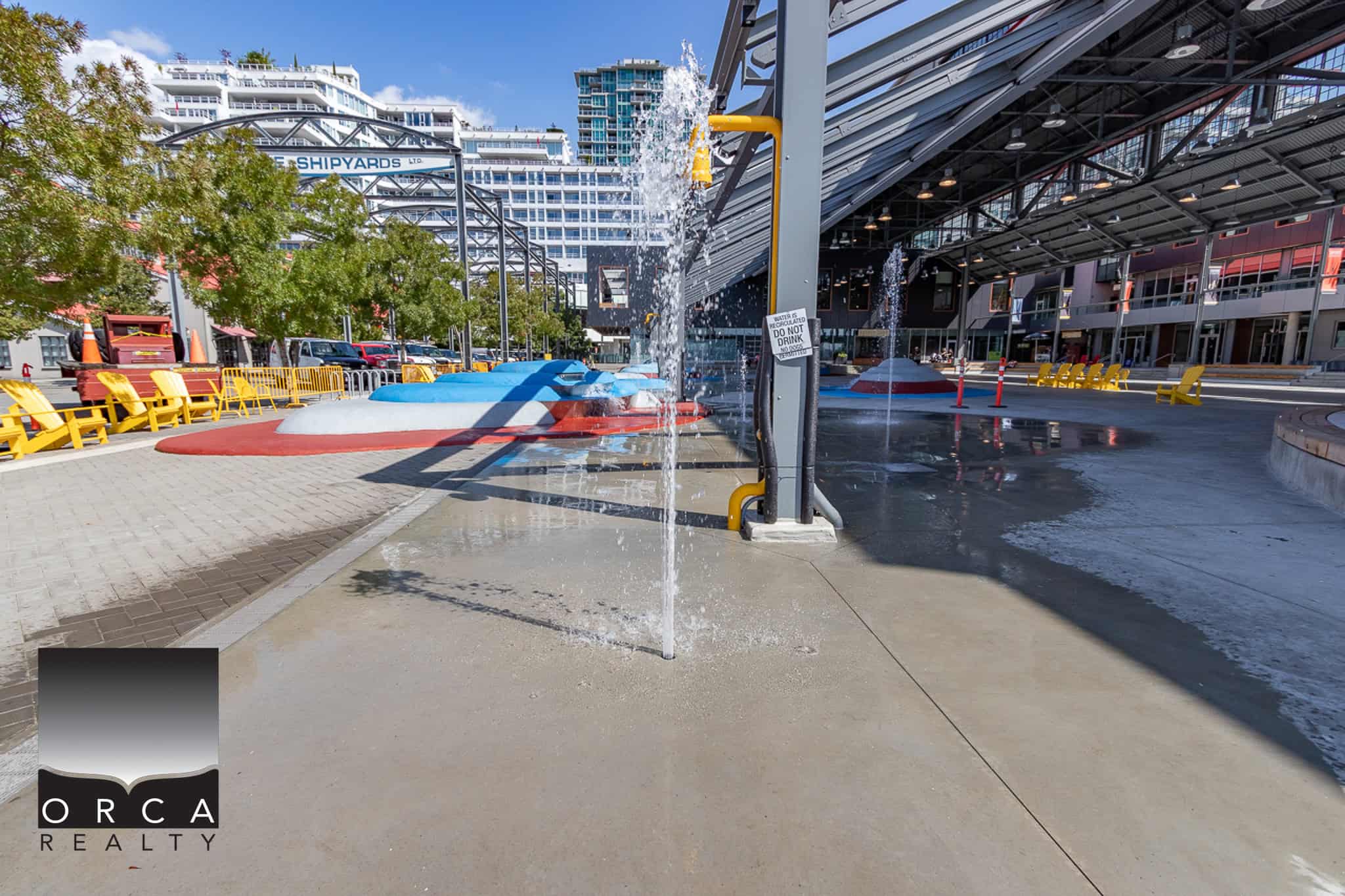 Refreshing waterfront water feature at Orca Realty Inc. office in Vancouver, BC, showcasing modern urban architecture, public outdoor space, and contemporary business environment in a vibrant downtown setting.