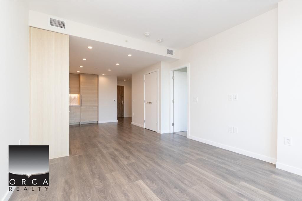 Bright modern Vancouver apartment interior with minimalist design, hardwood floors, spacious living area, and natural light, ideal for real estate listings and property investment in BC.