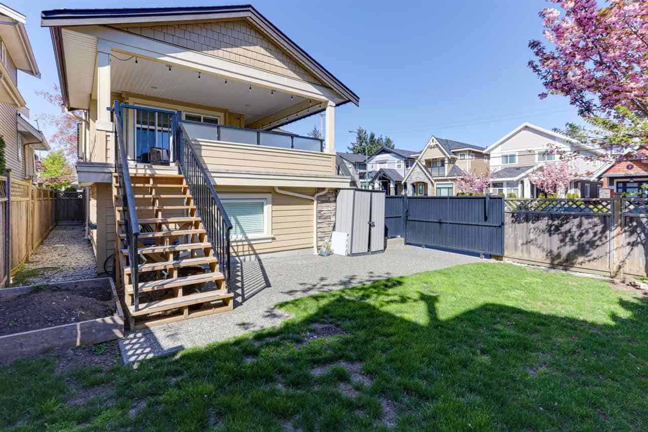 Modern two-story backyard home with deck, outdoor space, and garden area in Vancouver, BC. Perfect for families and property investment. Attractive, well-maintained residential property with charming garden and privacy fencing.