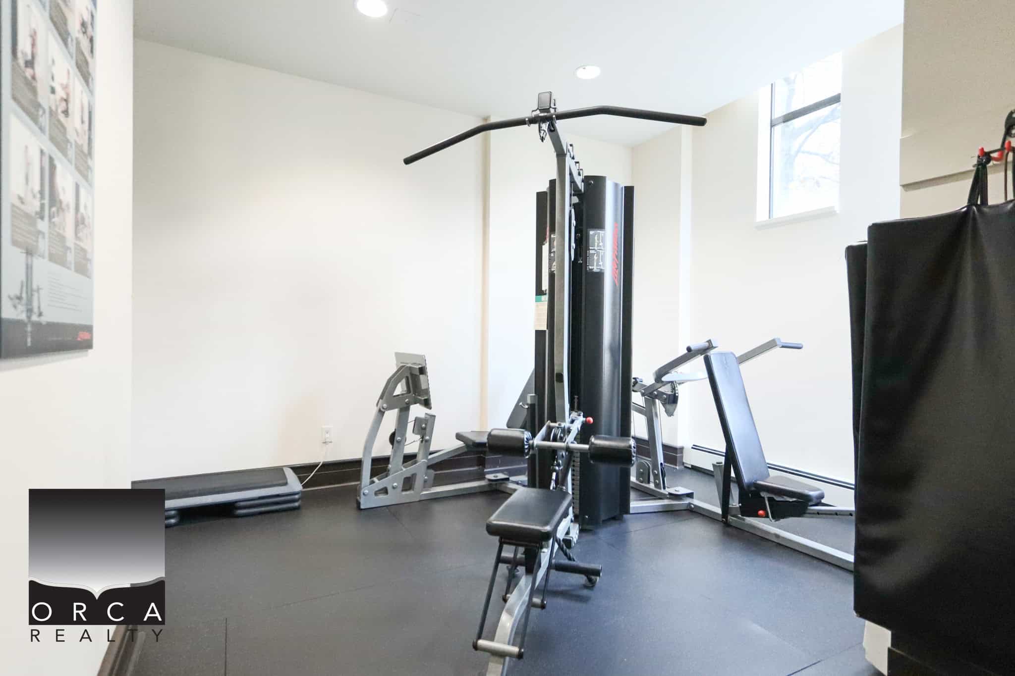 Home gym with workout equipment in North Vancouver condo at 203-170 W 1st Street.