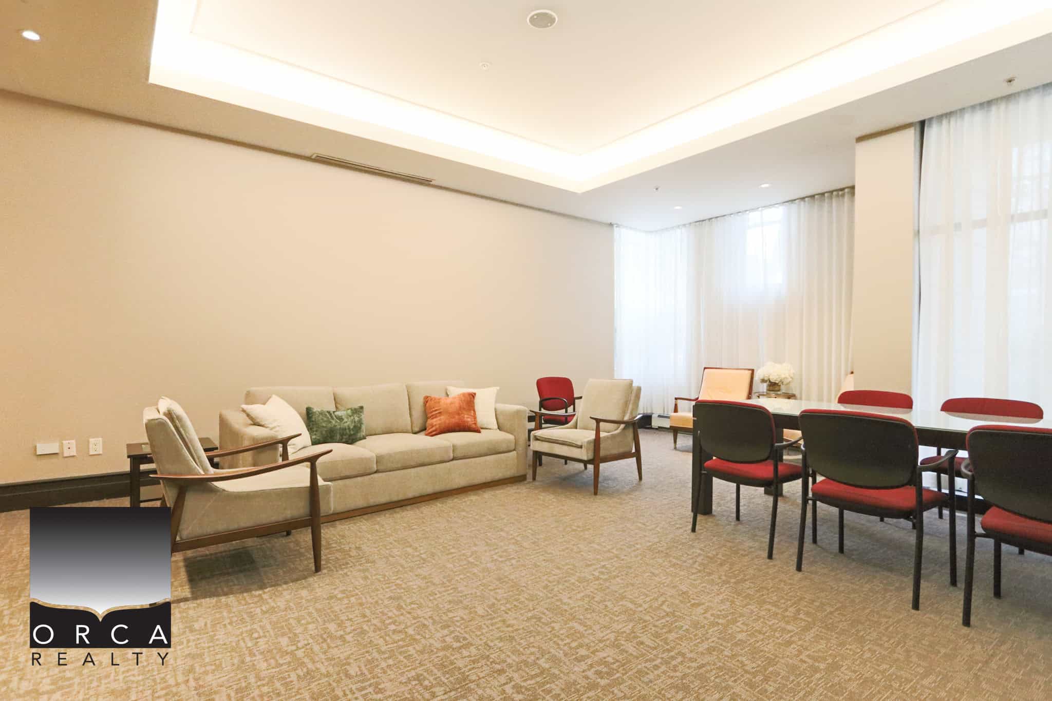 Spacious interior of 203-170 W 1st Street, North Vancouver, showcasing a comfortable lounge and dining area perfect for relaxing or entertaining guests.