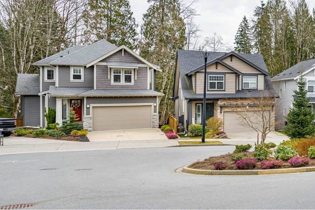 Modern duplex homes with landscaped front yards in a suburban neighbourhood, perfect for real estate investment and family living in Canada.