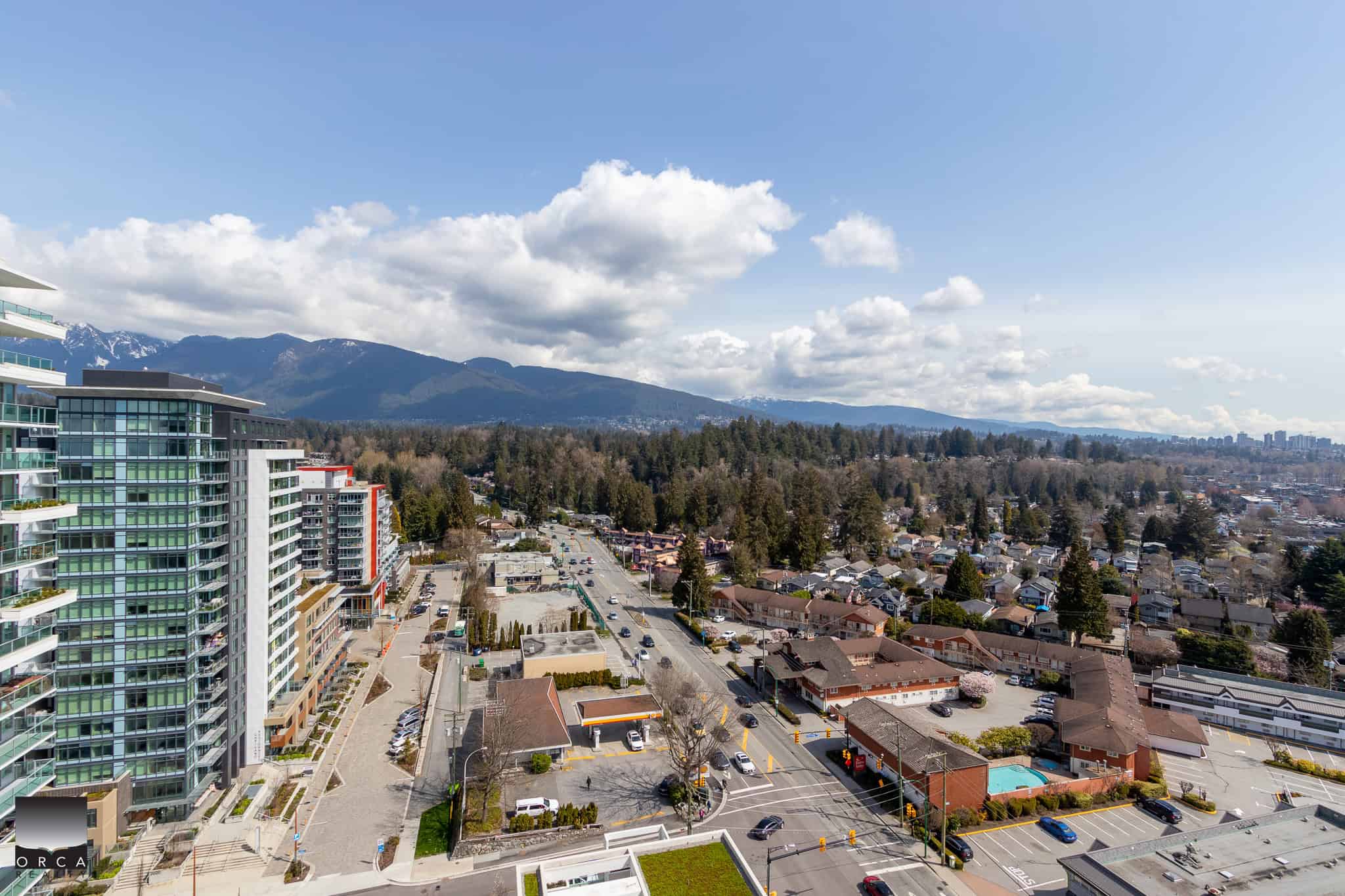 Modern Vancouver neighbourhood with high-rise condos, scenic mountain views, and a vibrant community; ideal for real estate investment and residential living in BC.