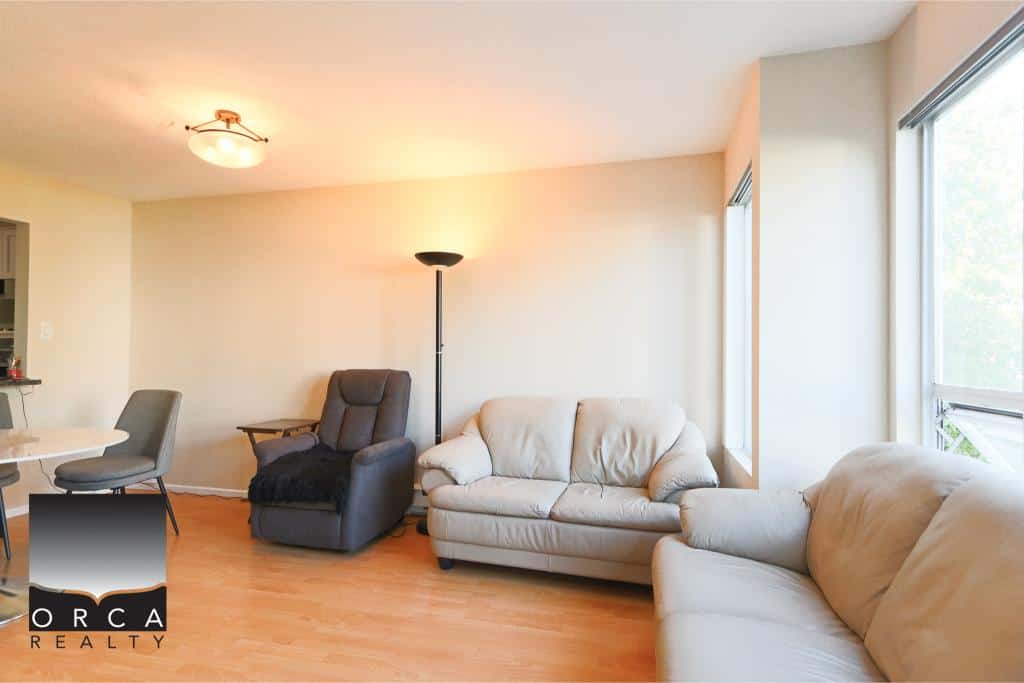 Modern living room in a Vancouver-area home showcasing comfortable sofas, natural light, and a cozy atmosphere, ideal for family living or entertaining guests.