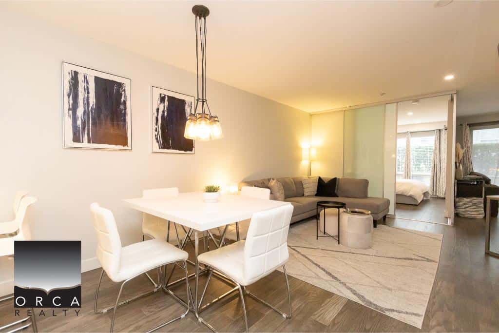 Modern living and dining area in a Vancouver condo with stylish furniture and contemporary decor. Bright, spacious, open-plan layout with seamless transition to the bedroom and natural light.