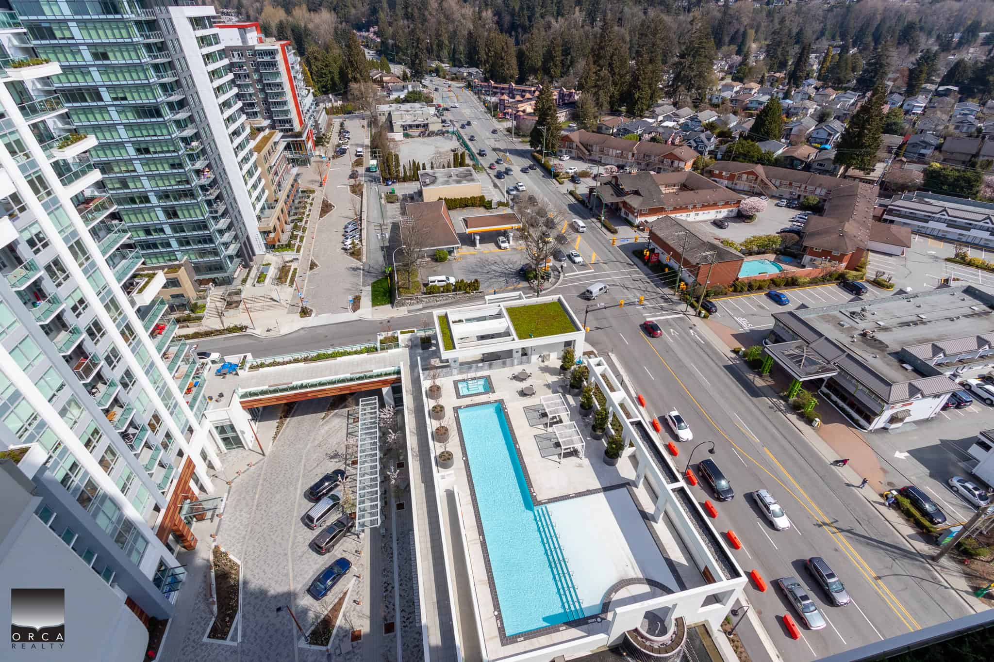 Modern high-rise condo building in Vancouver with rooftop pool and amenities, offering prime Vancouver real estate investment opportunities and luxury urban living.