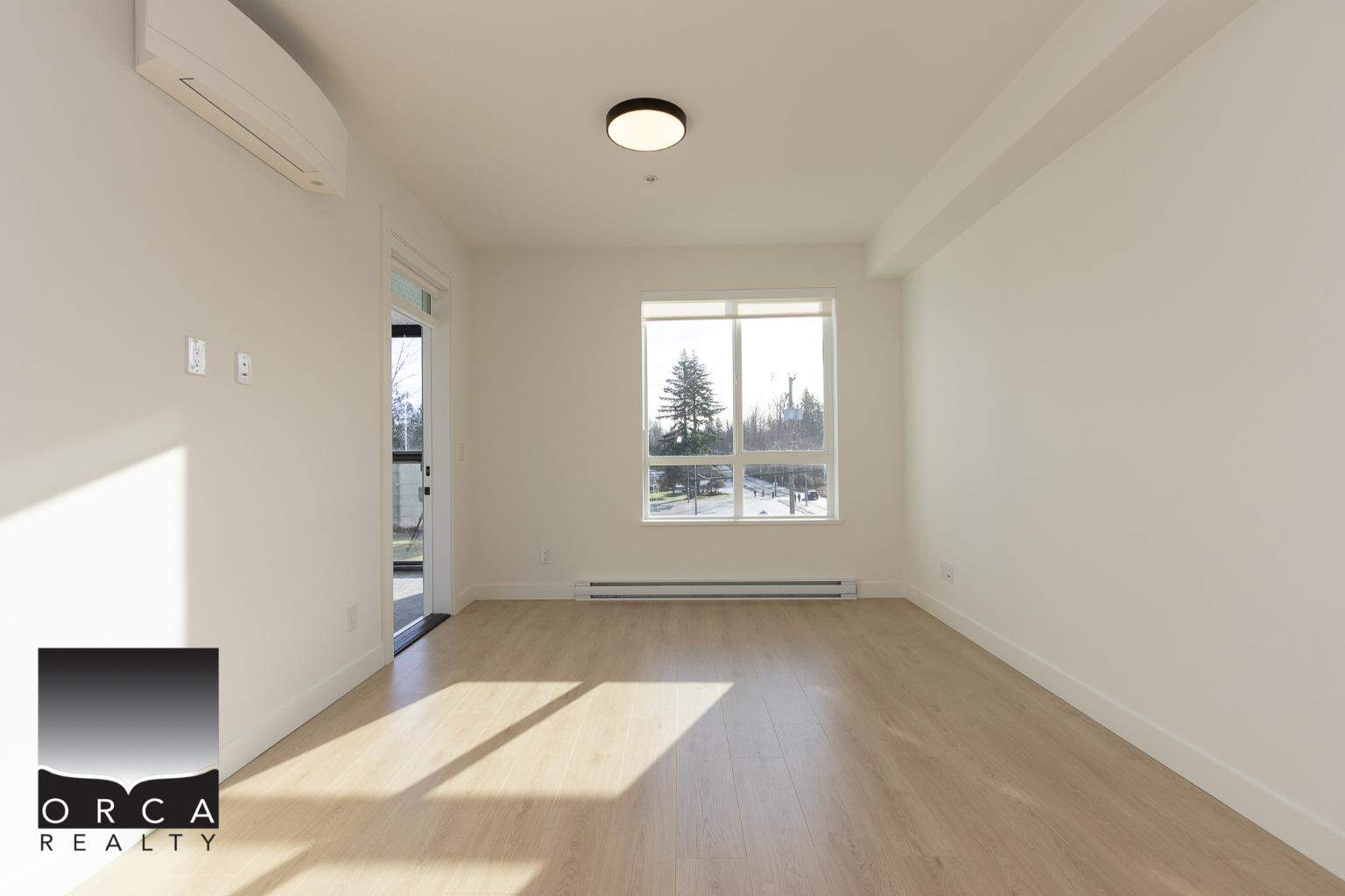 Bright and spacious living room in a modern Canadian home, featuring large windows, light wood flooring, and neutral walls, perfect for family living and entertaining.