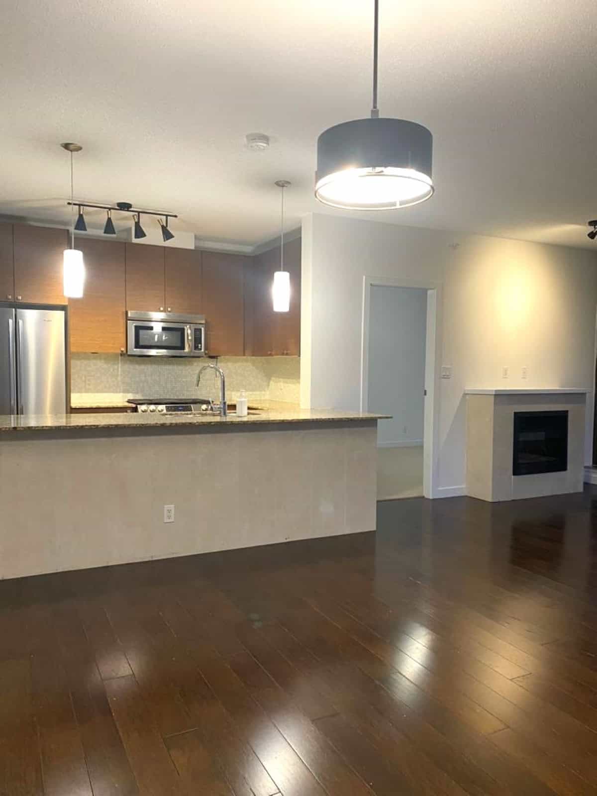 Modern open-concept kitchen with stainless steel appliances and granite countertops, ideal for Vancouver-area homebuyers seeking stylish property listings.