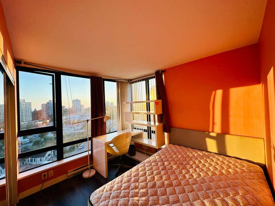 Bright city view studio apartment with large windows, modern decor, and natural light, ideal for Vancouver real estate buyers and investors seeking downtown condos.