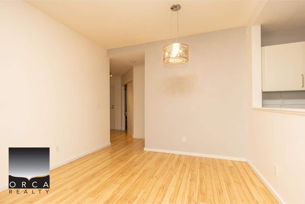 Bright contemporary living space with hardwood floors, modern lighting, and open layout, perfect for Ottawa homebuyers seeking a cozy and stylish residence.