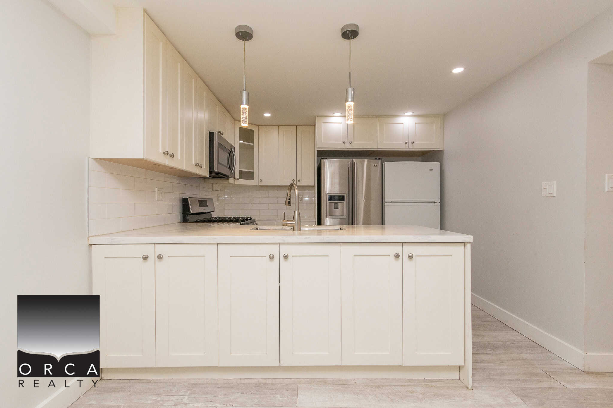 Bright modern kitchen with white cabinetry and stainless steel appliances, perfect for homebuyers seeking a stylish and functional space in Vancouver.