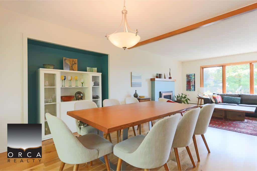 Bright dining room with modern decor and large windows showcasing natural light, perfect for family gatherings and entertaining guests in Vancouver's real estate market.