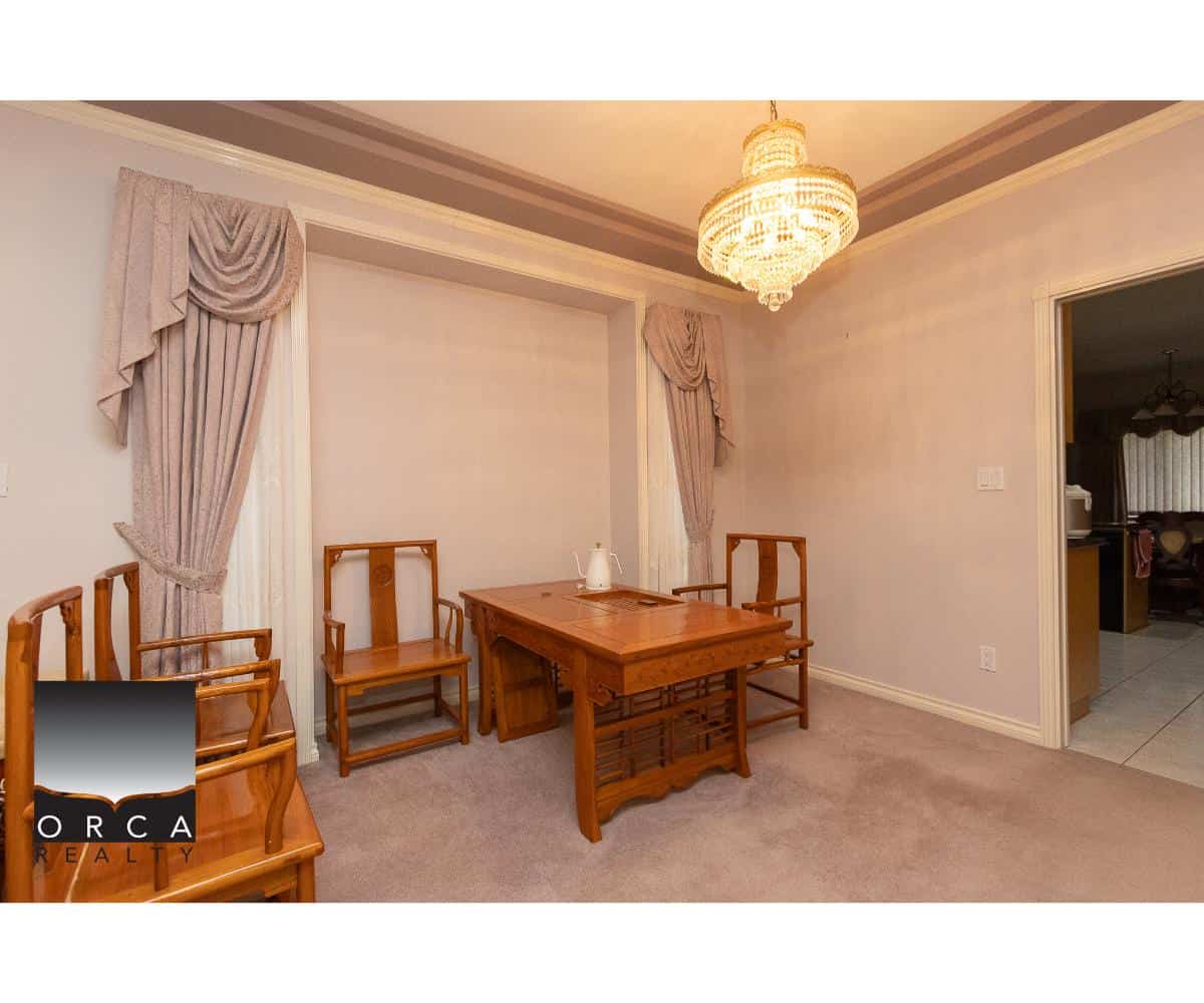 Orca Realty Inc. real estate listing featuring a traditional dining room with wooden chairs, chandelier, and elegant curtains, showcasing a cozy home interior in Canada.