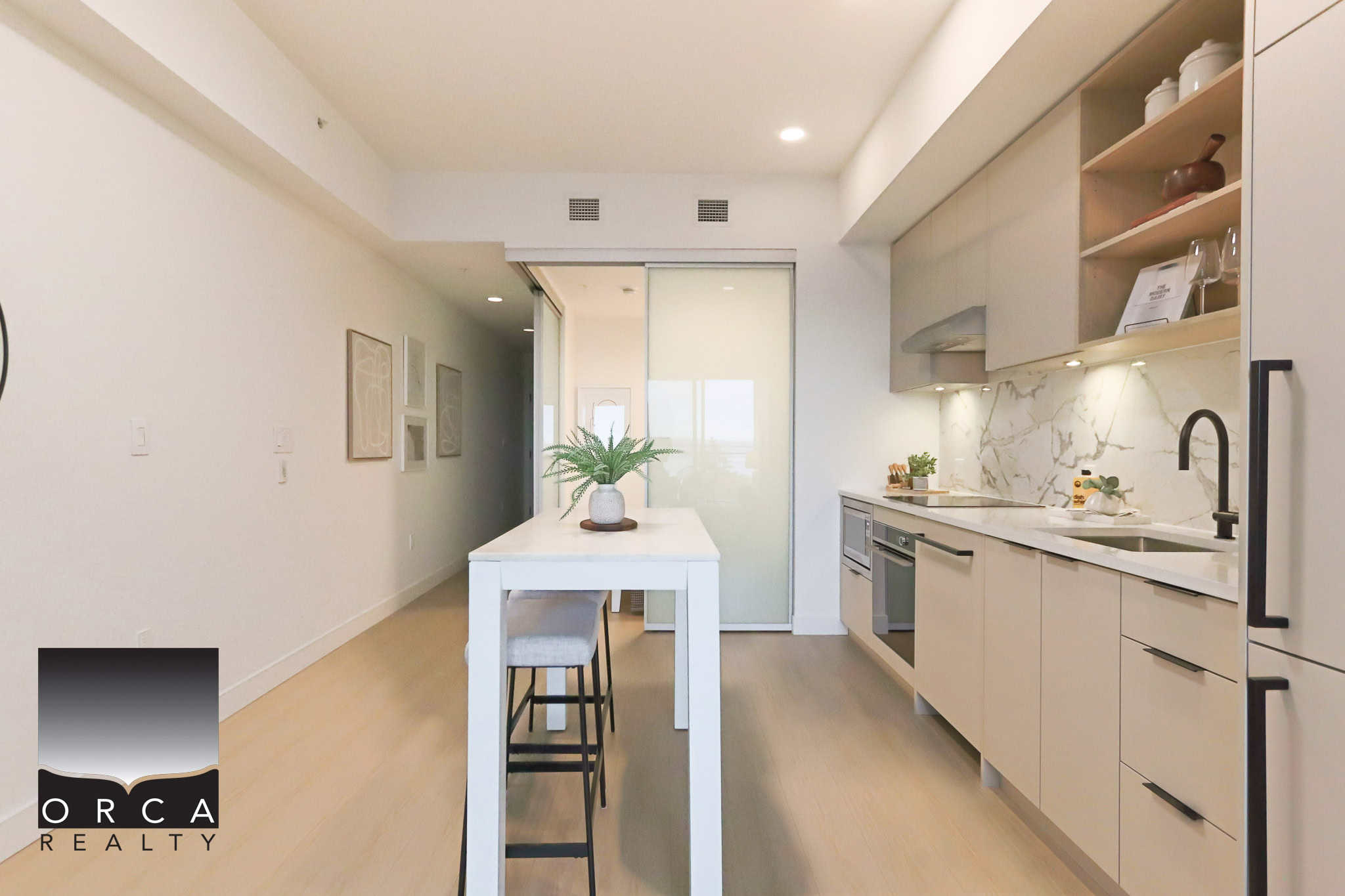 Modern minimalist kitchen with sleek white cabinetry and marble backsplash, perfect for contemporary home living in Vancouver.