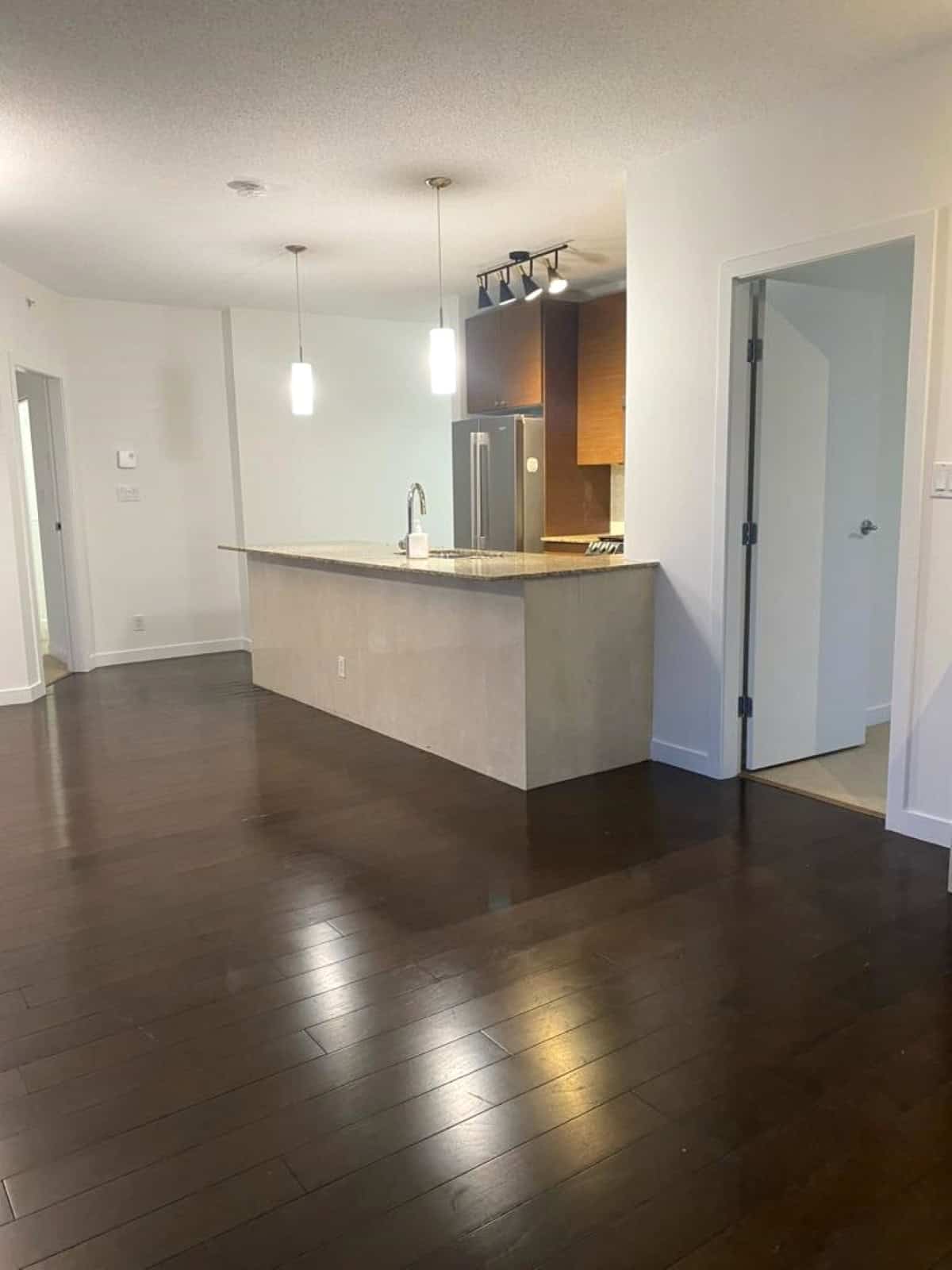 Modern open-concept kitchen with sleek cabinetry, granite countertops, and stainless steel appliances in a contemporary Vancouver home. Perfect for family living and entertaining.