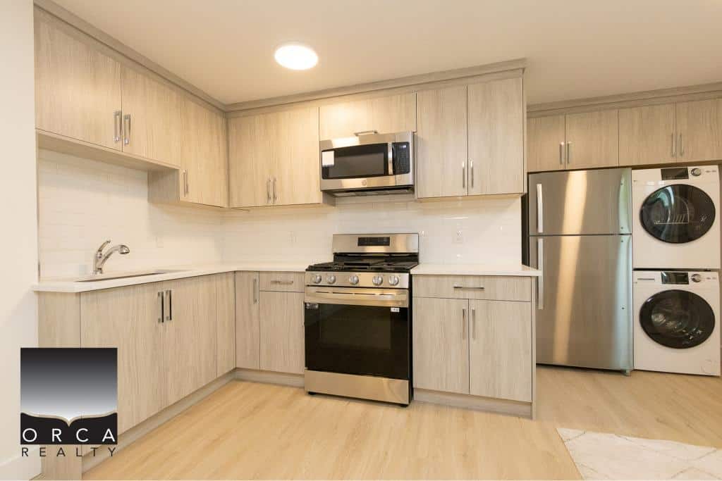 Modern kitchen with stainless steel appliances and light wood cabinetry, ideal for Vancouver real estate listings.