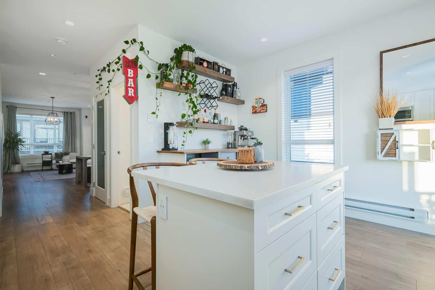 Bright and modern kitchen in a Vancouver home with white cabinetry, wooden accents, and stylish decor, showcasing the interior design expertise of Orca Realty Inc.