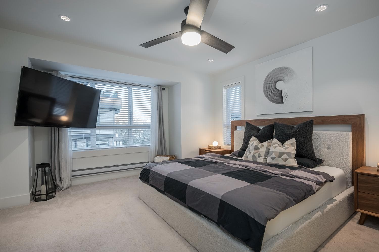 Bright modern bedroom with large window, stylish decor, and comfortable bedding, perfect for Vancouver real estate buyers searching for upscale homes in Fraser Valley.