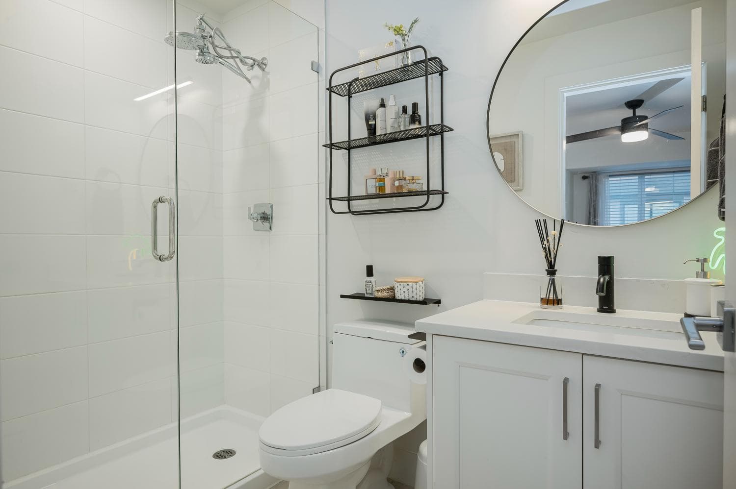 Bright modern bathroom with walk-in shower, sleek white fixtures, and stylish black accents, ideal for Vancouver homes and real estate listings.