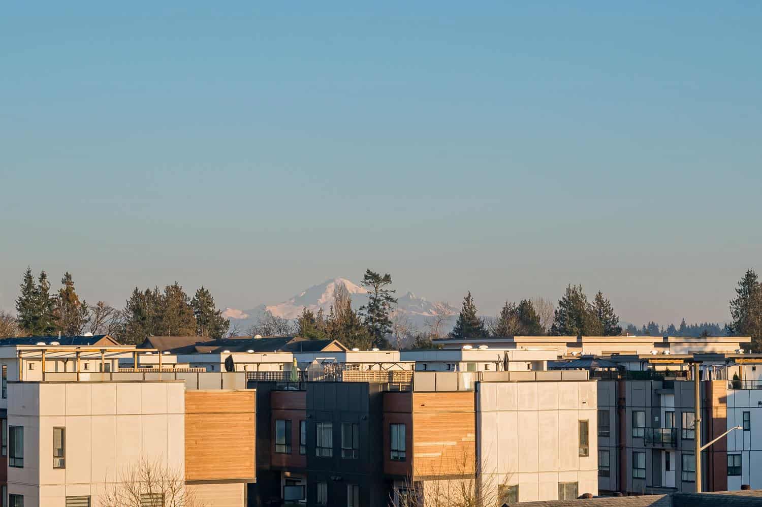 Modern residential apartments with mountain view in Vancouver, BC, showcasing contemporary architecture and scenic landscape. Perfect for real estate investments or homebuyers seeking urban living.