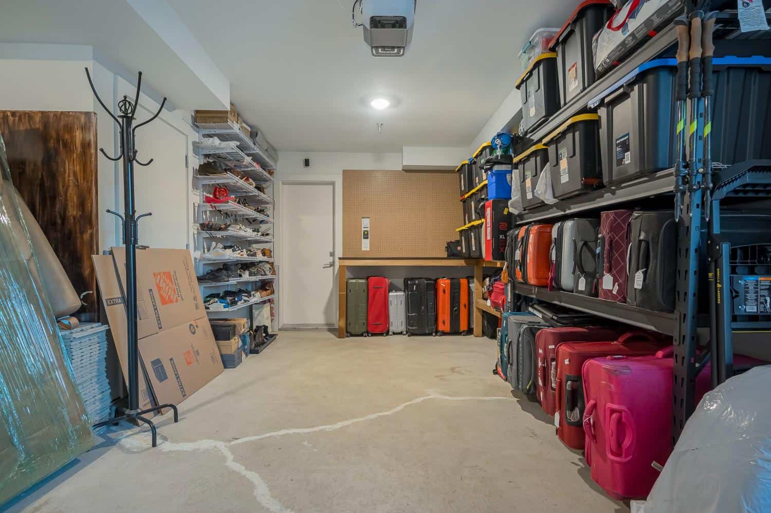 Storage room with organized suitcases and household items in a modern home.