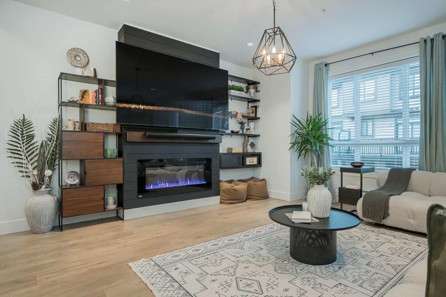 Contemporary living room with modern fireplace, stylish wall-mounted TV, and cozy seating area; perfect for homebuyers seeking stylish interior spaces in Vancouver.