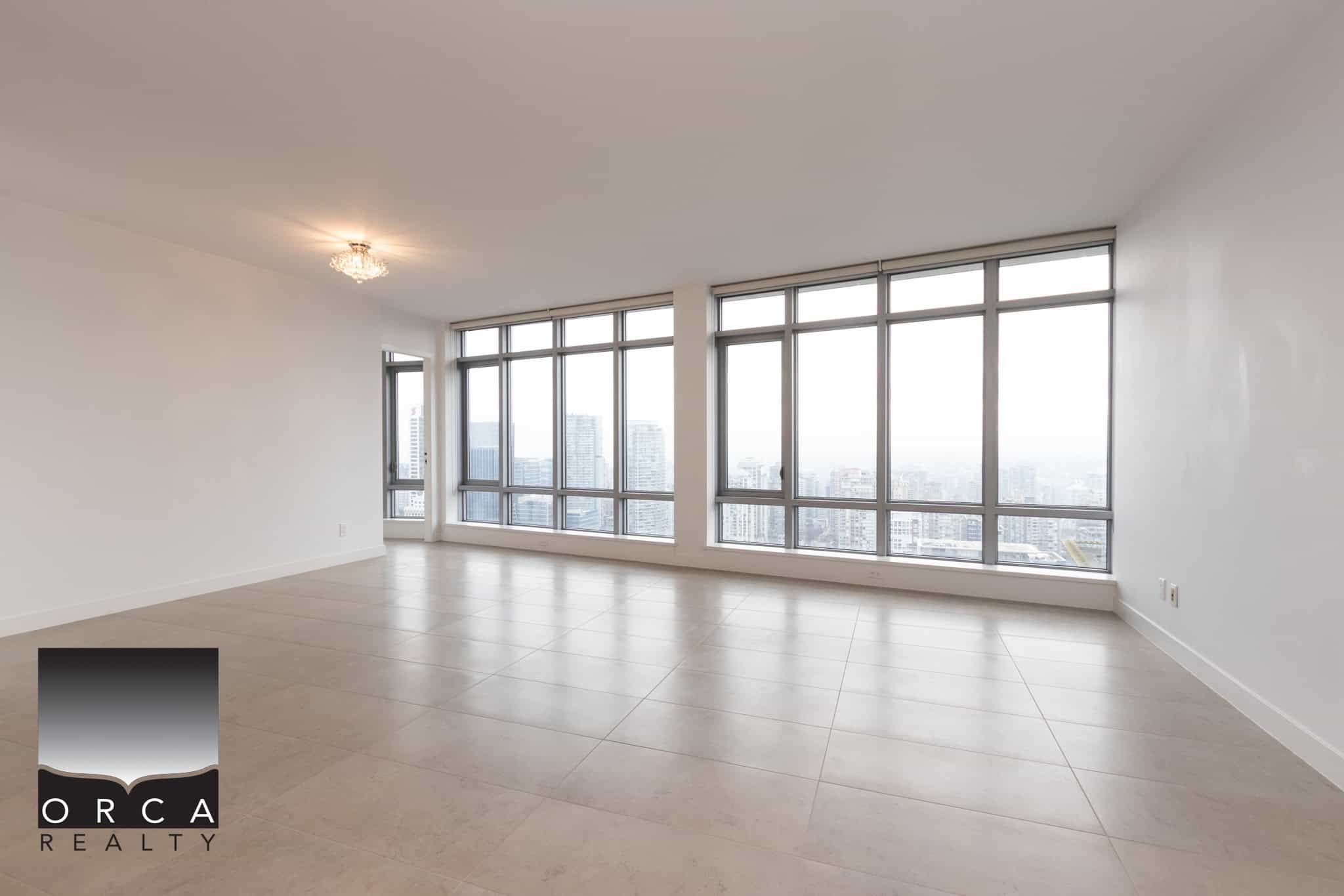 Spacious modern condominium with large windows offering stunning city views, high ceilings, and contemporary finishes, ideal for upscale living in Vancouver’s skyline.