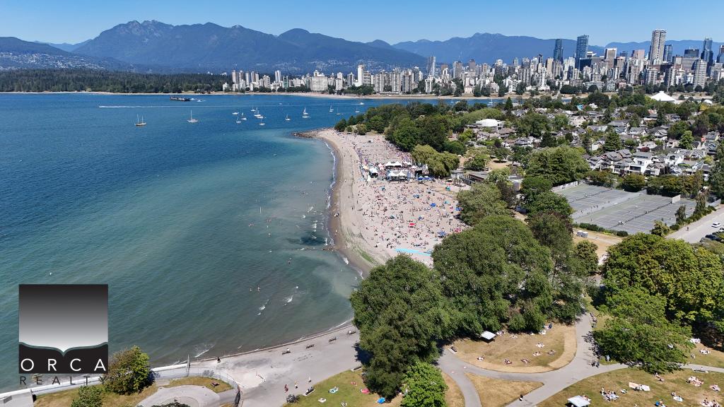 Vancouver beaches with city skyline and mountains in the background, showcasing waterfront property and coastal living in Vancouver, British Columbia.