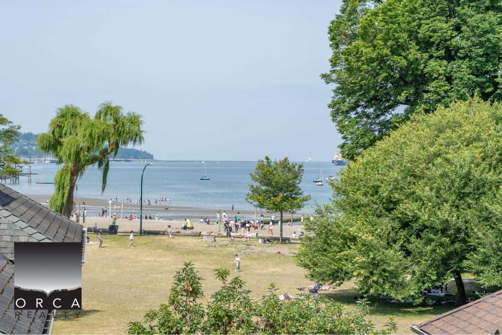 Beachfront views of the ocean and lush greenery in Victoria highlighted by Orca Realty Inc. showcasing prime real estate opportunities in a scenic waterfront location.