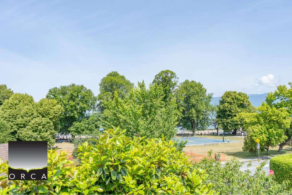 Lush green trees and park scenery in a peaceful residential neighbourhood on Vancouver Island, perfect for real estate investment and family living.